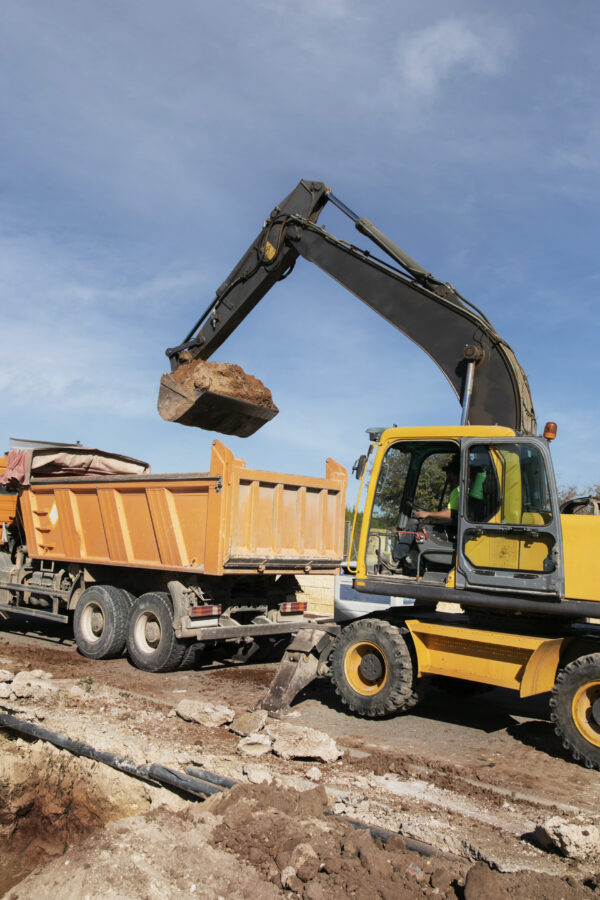excavator digging ground day light